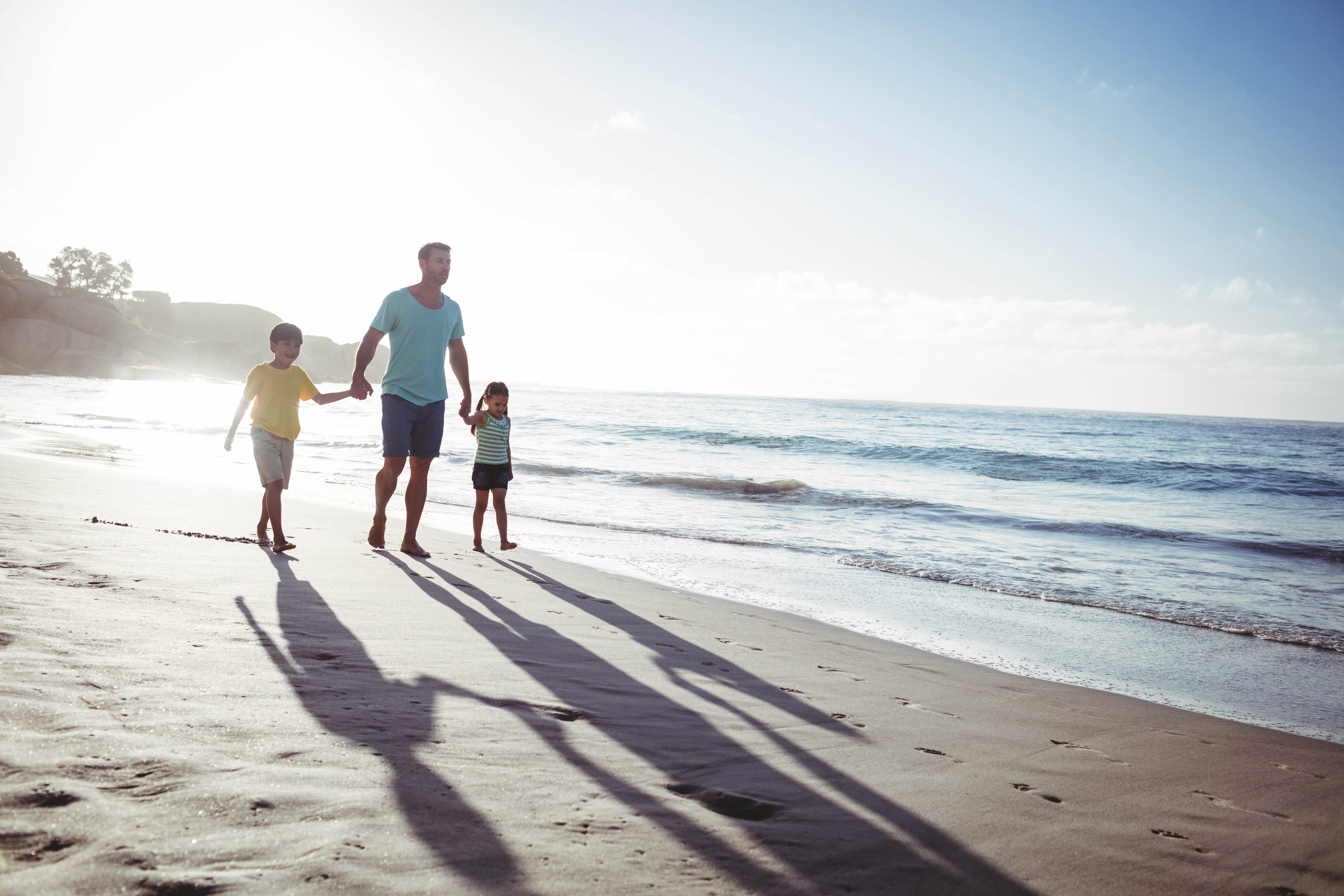 man with kids walking