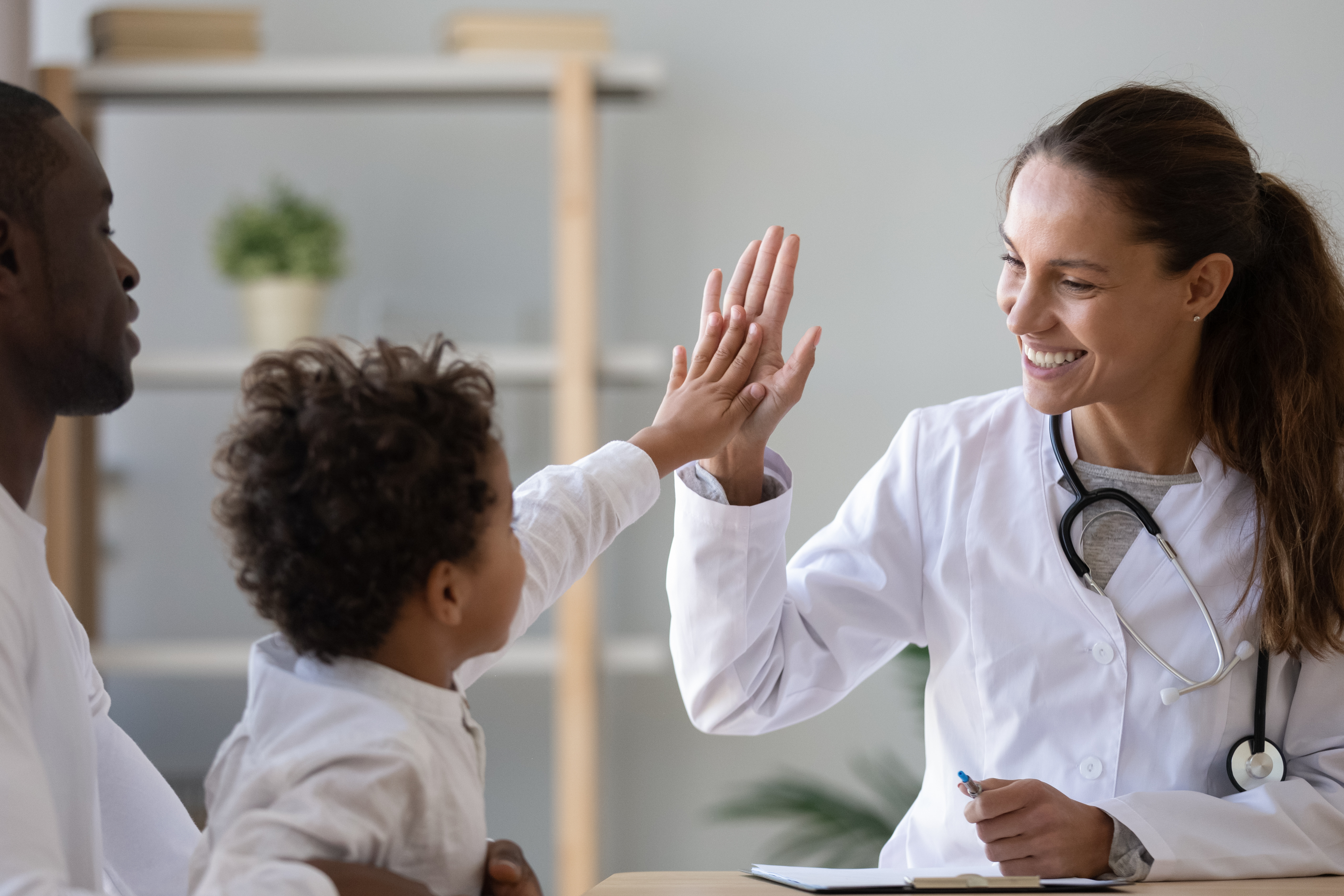 Doctor high fiving a child